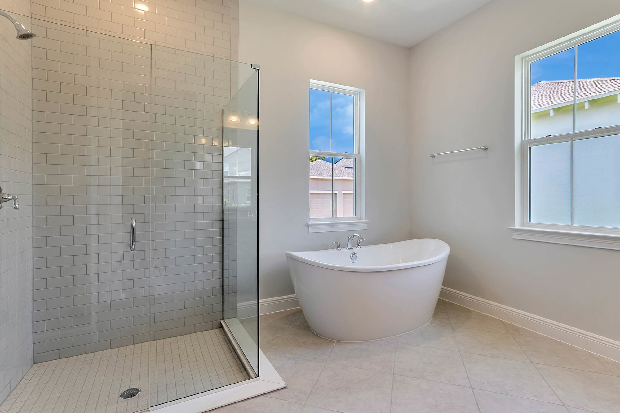 bathroom with glass walk in shower and tub